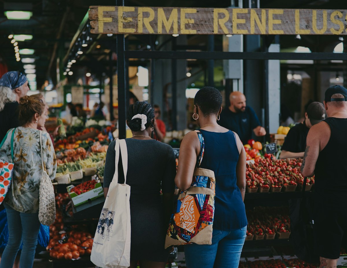 Shoppers at a produce stall in Montréal’s Jean-Talon Market